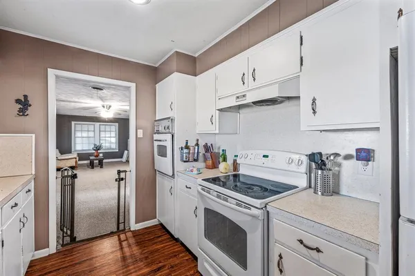 a kitchen with a refrigerator sink and cabinets