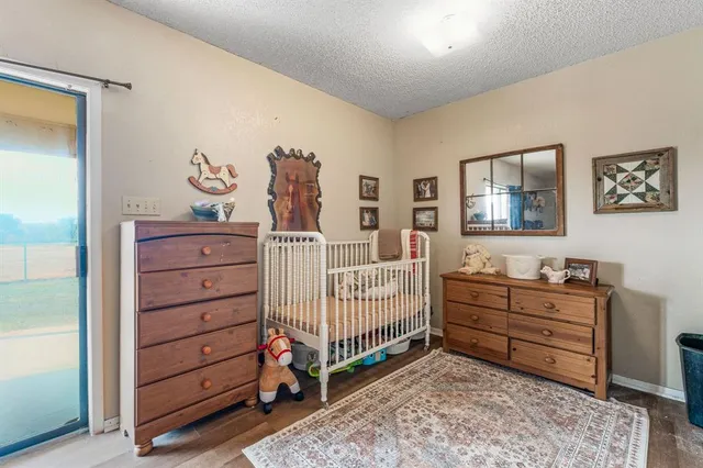 a bedroom with a baby bed and a dresser