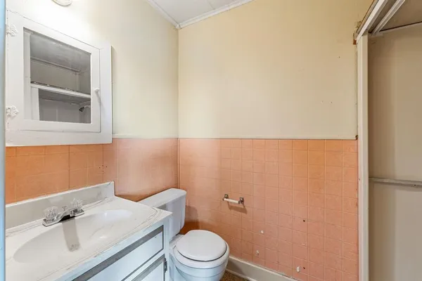 a bathroom with a sink a toilet and mirror