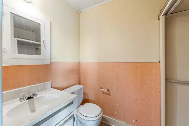 a bathroom with a sink a toilet and mirror