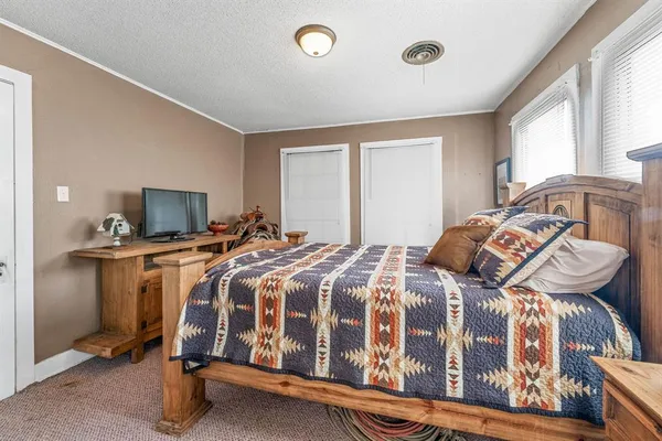 a bedroom with a bed and a tv