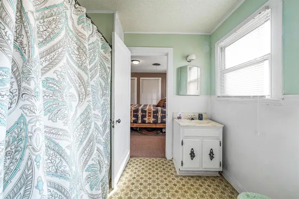 a bathroom with a sink a toilet and mirror