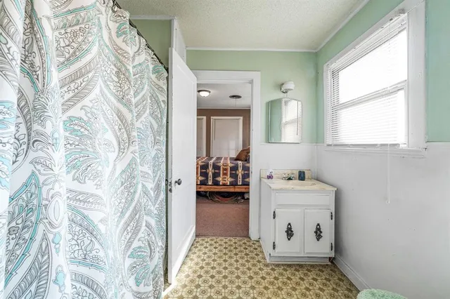 a bathroom with a sink a toilet and mirror