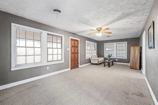 a view of a livingroom with furniture and a ceiling fan