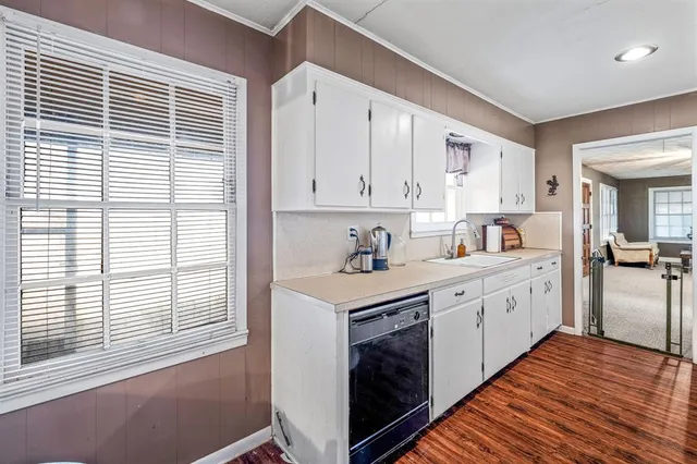 a kitchen with wooden cabinets and sink
