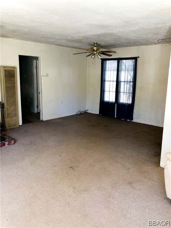 564 Riverside Avenue Sugarloaf, CA 92386 - Photo 5 of 17 an empty room with windows