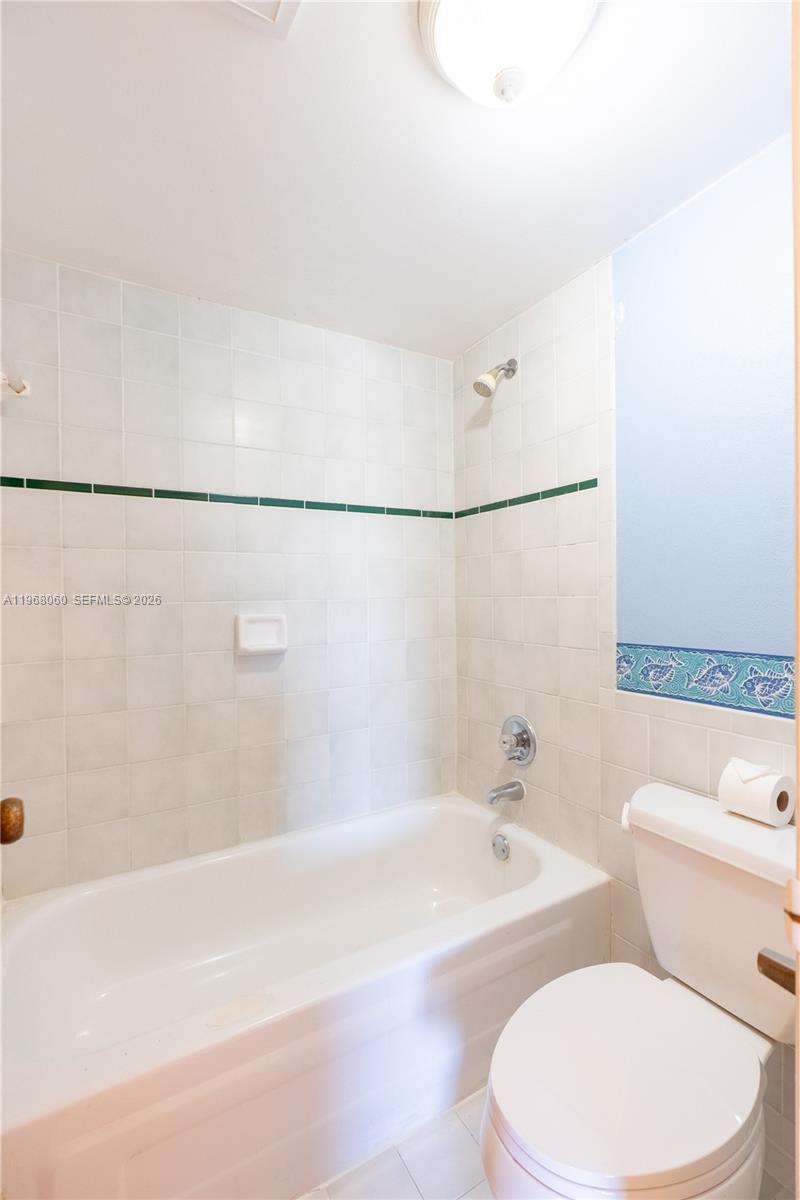 430 Commodore Drive, Unit 314 Plantation, FL 33325 - Photo 12 of 54 a white toilet sitting next to a bath tub