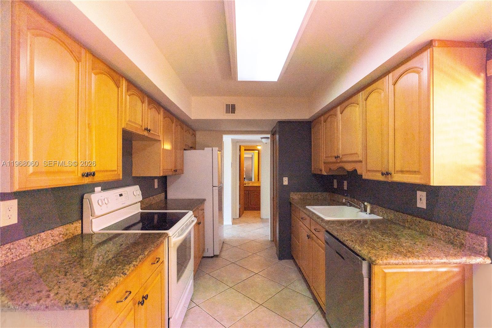 430 Commodore Drive, Unit 314 Plantation, FL 33325 - Photo 2 of 54 a kitchen with a stove a sink and a refrigerator