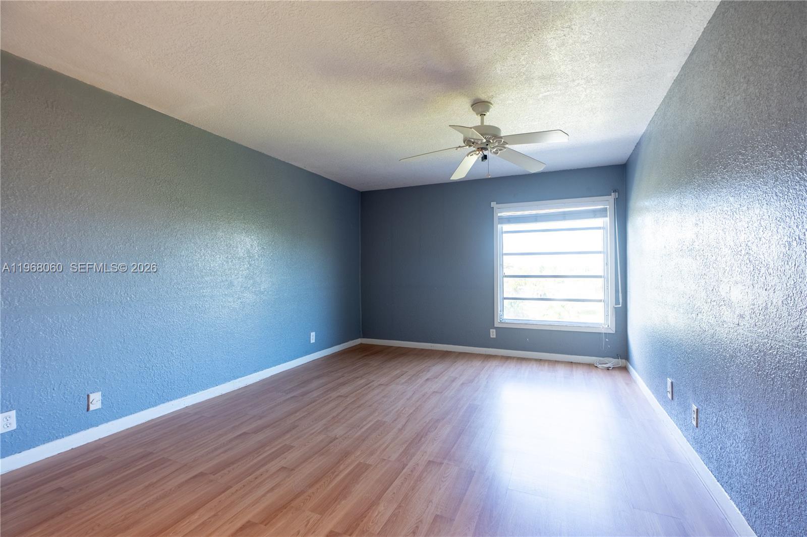 430 Commodore Drive, Unit 314 Plantation, FL 33325 - Photo 29 of 54 an empty room with wooden floor and windows