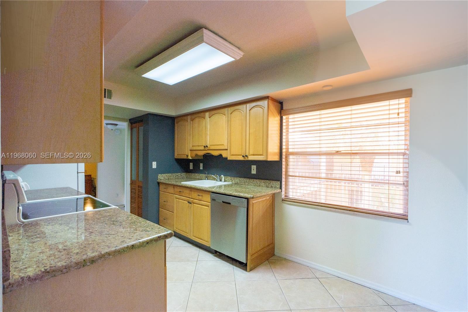 430 Commodore Drive, Unit 314 Plantation, FL 33325 - Photo 33 of 54 a kitchen with stainless steel appliances granite countertop a stove a sink and a microwave