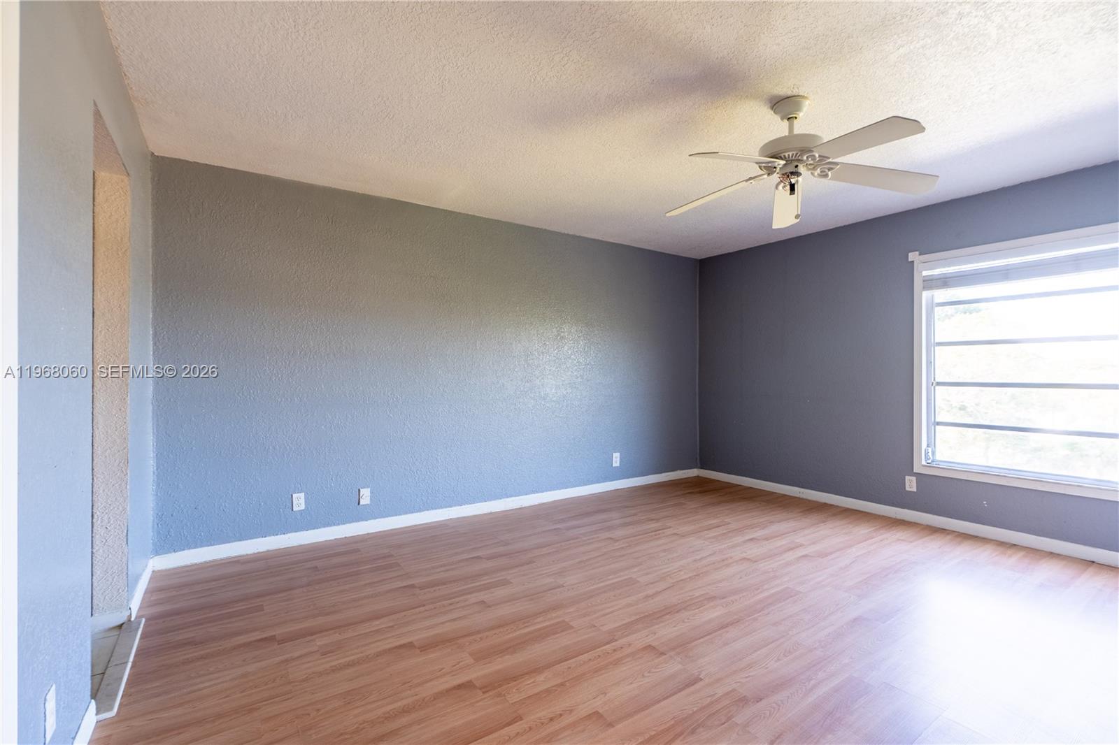 430 Commodore Drive, Unit 314 Plantation, FL 33325 - Photo 40 of 54 an empty room with wooden floor fan and windows