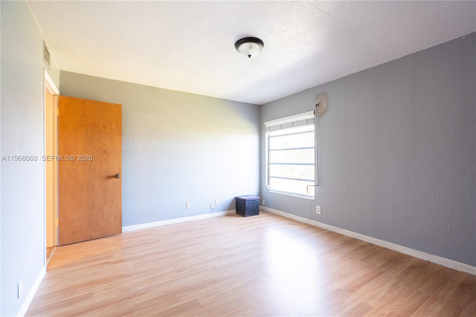 430 Commodore Drive, Unit 314 Plantation, FL 33325 - Photo 6 of 54 a view of empty room with wooden floor and fan
