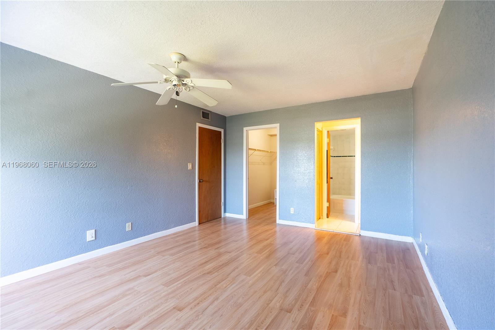 430 Commodore Drive, Unit 314 Plantation, FL 33325 - Photo 7 of 54 a view of an empty room with window and wooden floor