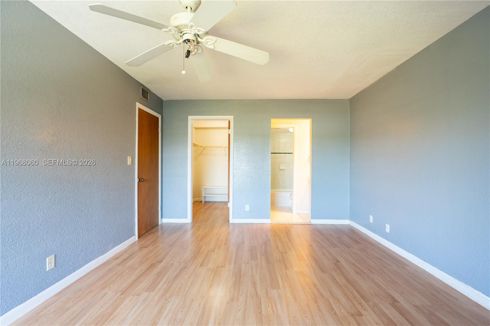 430 Commodore Drive, Unit 314 Plantation, FL 33325 - Photo 10 of 54 wooden floor in an empty room with a window