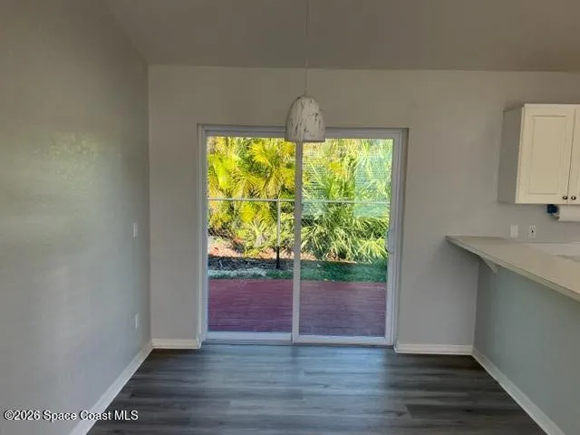 a spacious bedroom with a bed and a window