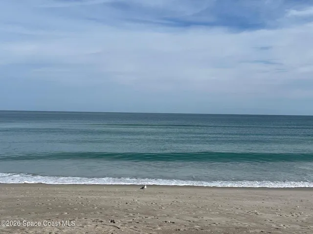 a spacious bedroom with a bed and a window