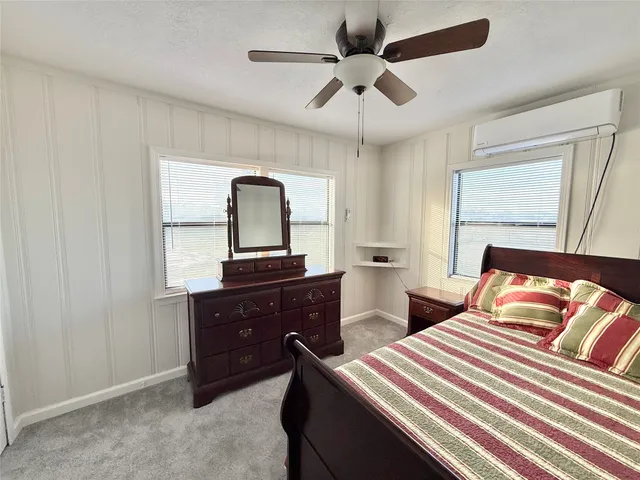 a bathroom with a granite countertop shower and a mirror