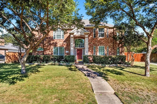 a view of a brick building next to a yard