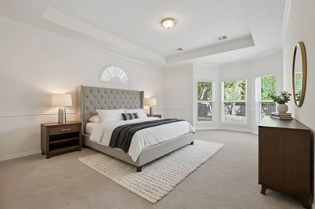 a bathroom with a tub a sink and mirror