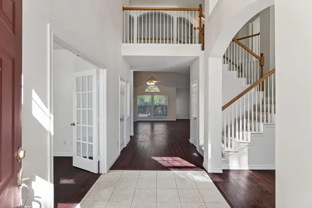 a view of a hallway with wooden floor and staircase
