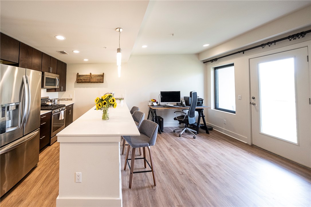 1603 Enfield Road, Unit 306 Austin, TX 78703 - Photo 5 of 16 Kitchen Dining/Flex Space. Currently Used as Home Office Space, but perfect if you're needing room for your Dining Table. 10 Foot x 41" Deep Kitchen Island great for seating 4 comfortably. Opens up to Covered Balcony with Wonderful Downtown Views.