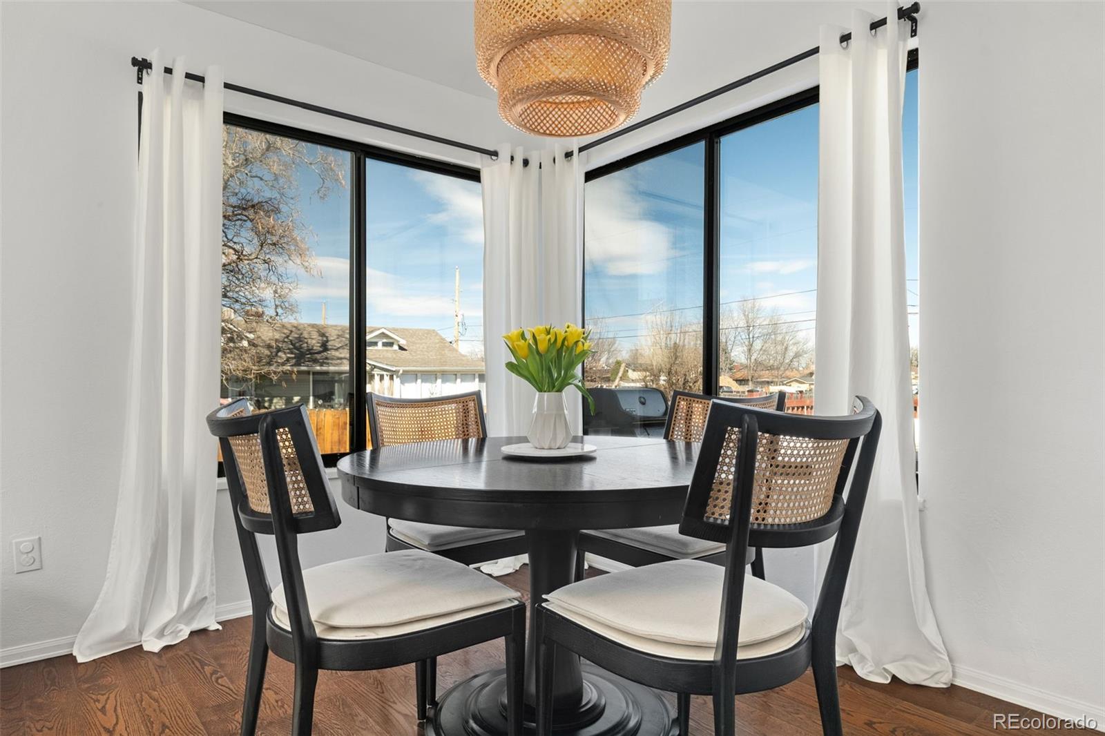 6404 Raleigh Street Arvada, CO 80003 - Photo 11 of 50 a view of a dining room with furniture window and wooden floor