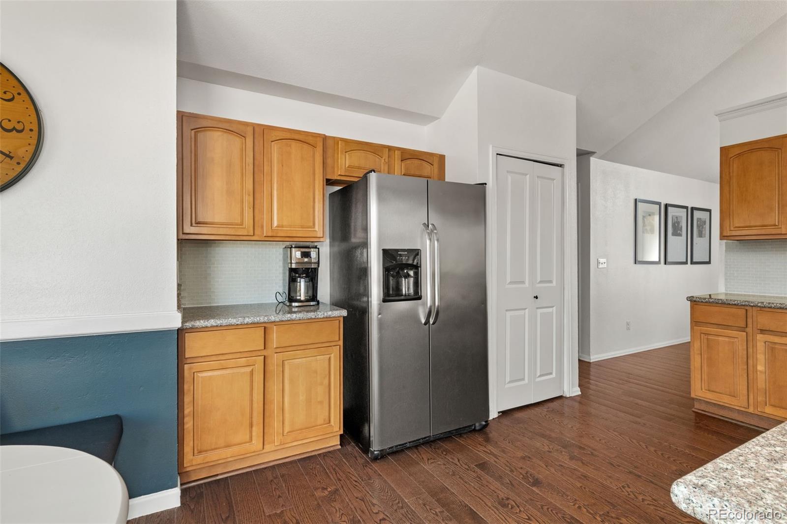 6404 Raleigh Street Arvada, CO 80003 - Photo 15 of 50 a kitchen with stainless steel appliances granite countertop a refrigerator and a stove top oven