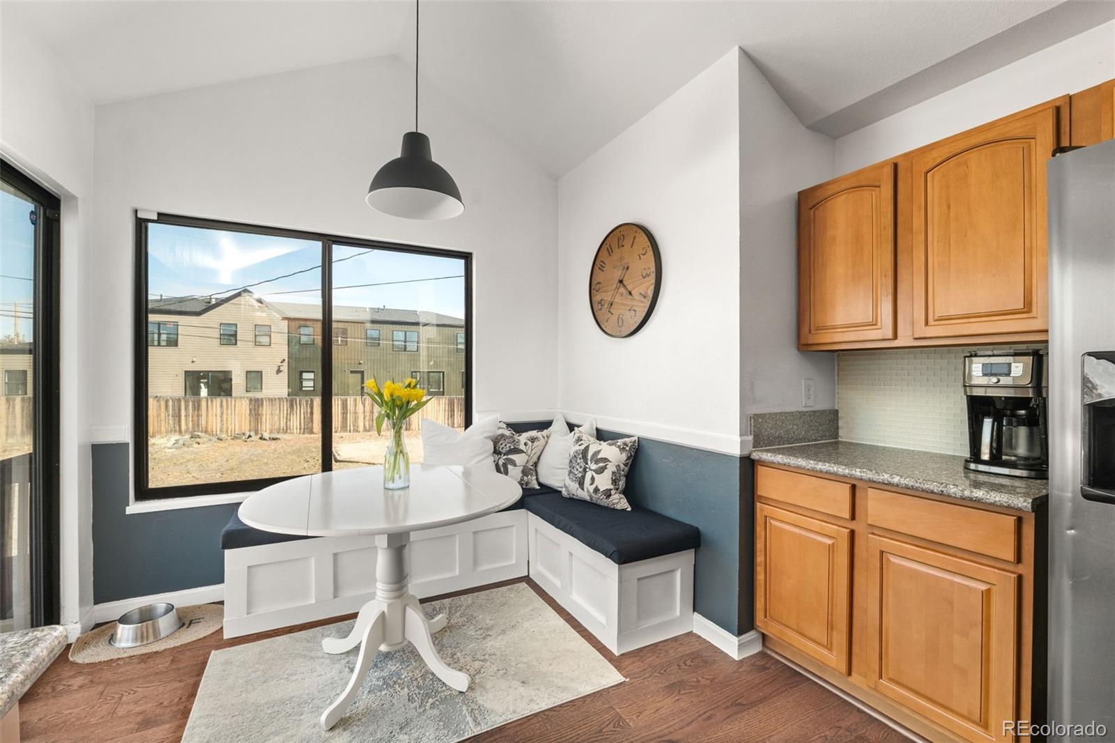 6404 Raleigh Street Arvada, CO 80003 - Photo 16 of 50 a living room with furniture a clock and a window