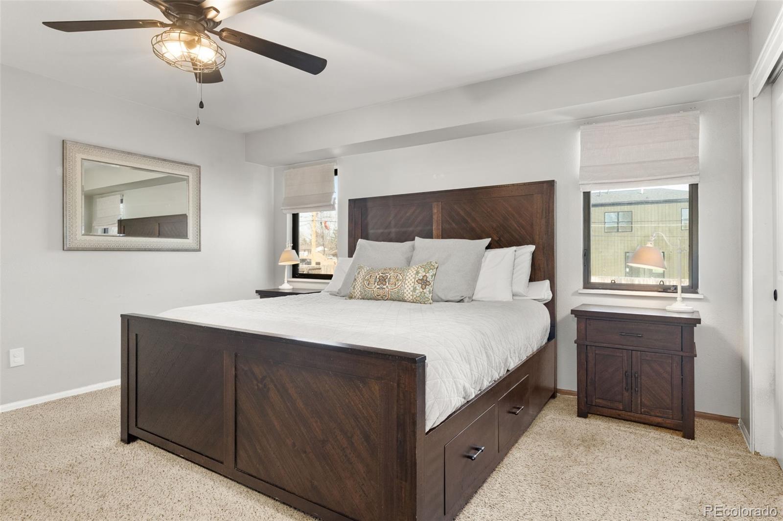 6404 Raleigh Street Arvada, CO 80003 - Photo 20 of 50 a bedroom with a bed and a chandelier