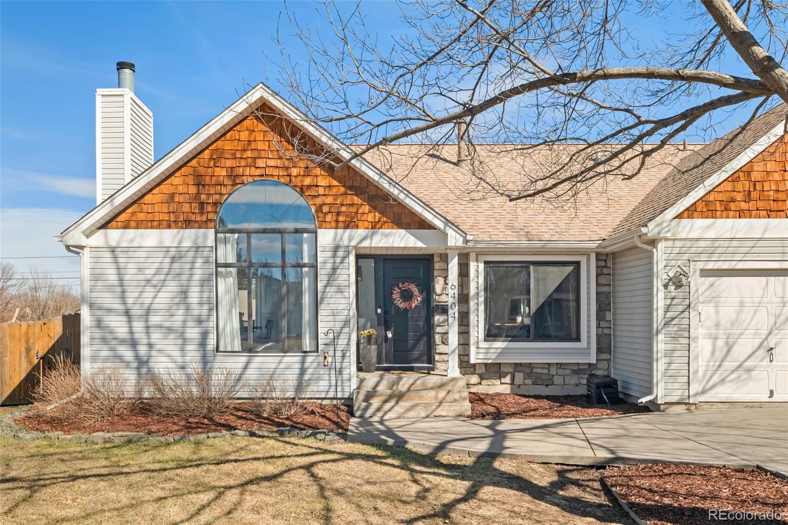 6404 Raleigh Street Arvada, CO 80003 - Photo 2 of 50 a front view of a house with a yard