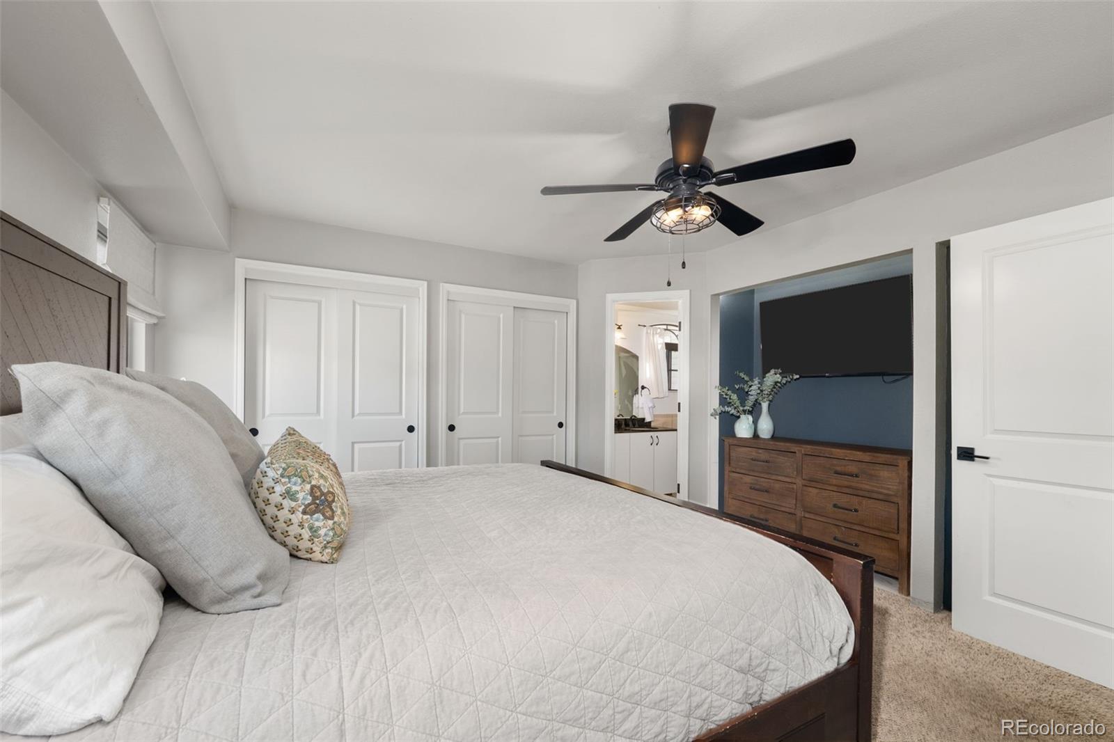 6404 Raleigh Street Arvada, CO 80003 - Photo 21 of 50 a bedroom with a bed and a chandelier