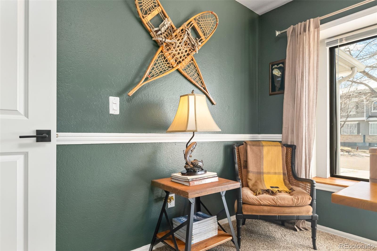 6404 Raleigh Street Arvada, CO 80003 - Photo 29 of 50 a living room with a table and a window