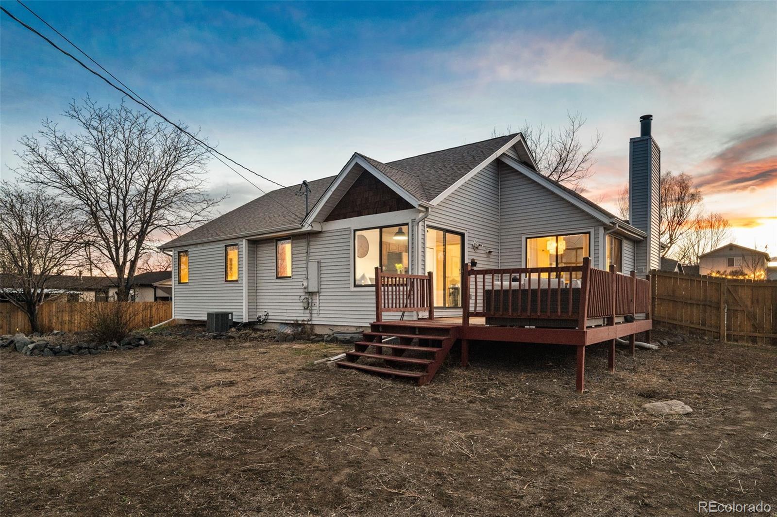 6404 Raleigh Street Arvada, CO 80003 - Photo 33 of 50 a view of a house with a yard and deck
