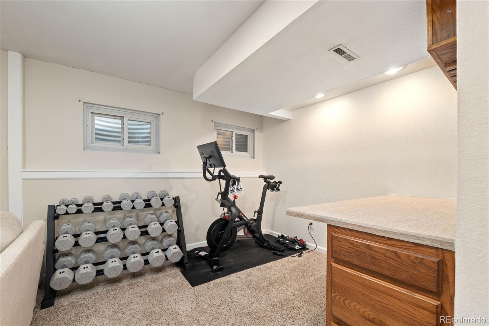 6404 Raleigh Street Arvada, CO 80003 - Photo 39 of 50 a room with gym equipment and a large window