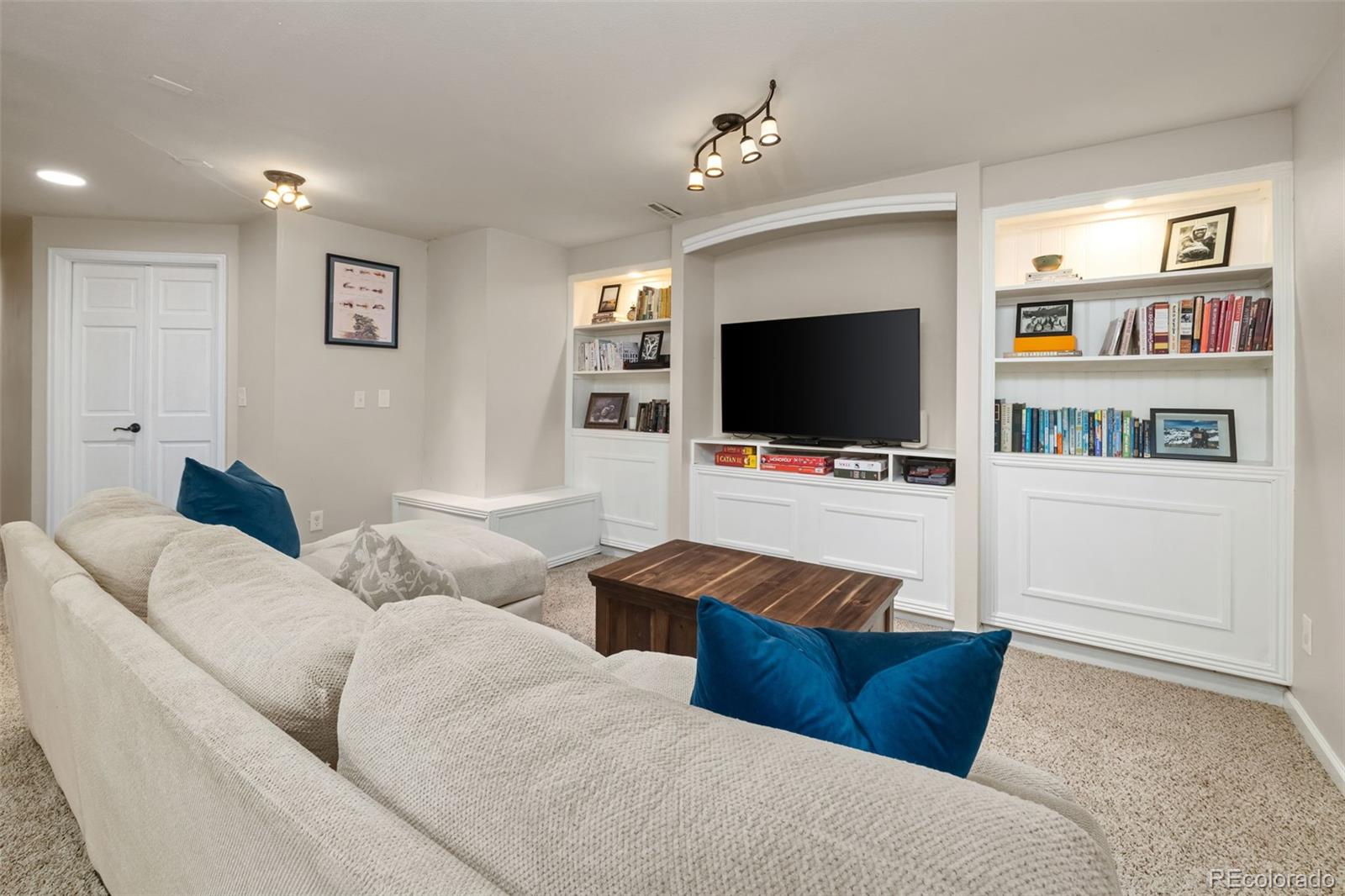 6404 Raleigh Street Arvada, CO 80003 - Photo 40 of 50 a living room with furniture and a flat screen tv