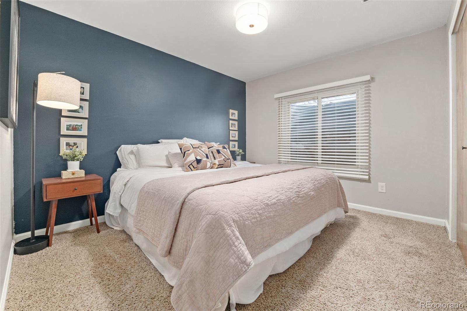 6404 Raleigh Street Arvada, CO 80003 - Photo 41 of 50 a bedroom with a bed mirror and a window