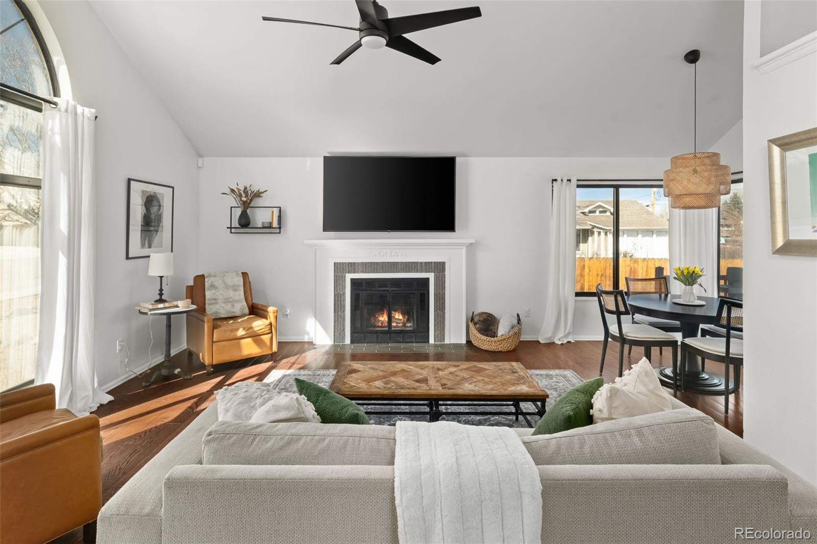 6404 Raleigh Street Arvada, CO 80003 - Photo 6 of 50 a living room with furniture and a fireplace