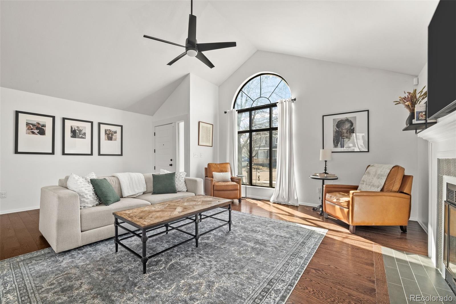 6404 Raleigh Street Arvada, CO 80003 - Photo 7 of 50 a living room with furniture a flat screen tv and a window