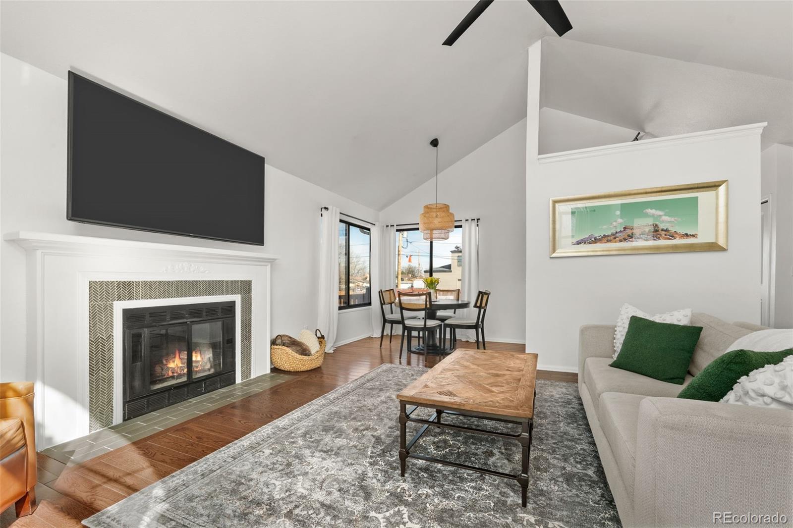 6404 Raleigh Street Arvada, CO 80003 - Photo 9 of 50 a living room with furniture a flat screen tv and a fireplace