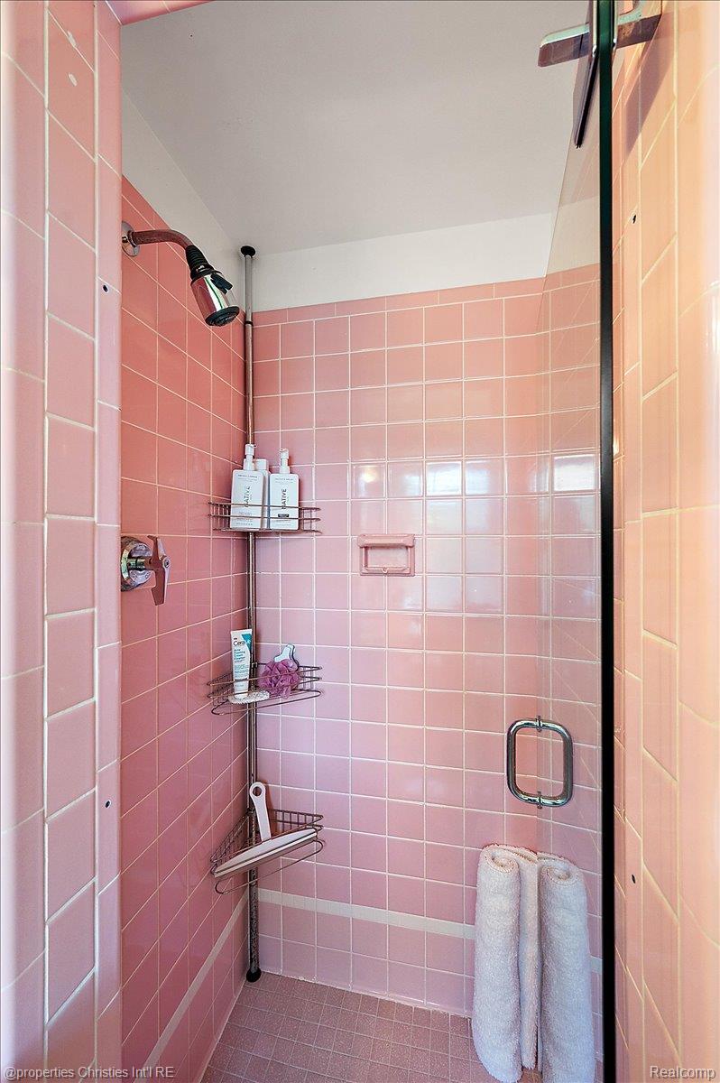 135 Clifton Road Bloomfield Hills, MI 48301 - Photo 49 of 77 Shower enclosure featuring pink square-tiled walls and a coordinating pink tiled floor