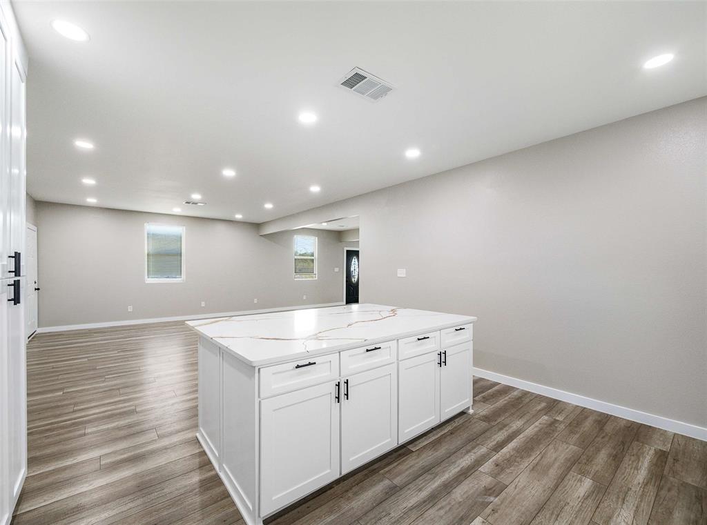 1061 Zmolek Road Ennis, TX 75119 - Photo 10 of 40 a kitchen with a sink window and a mirror