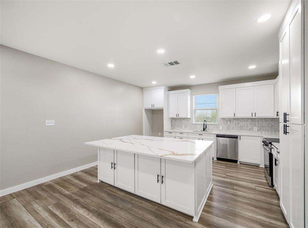 1061 Zmolek Road Ennis, TX 75119 - Photo 11 of 40 a large white kitchen with wooden floor