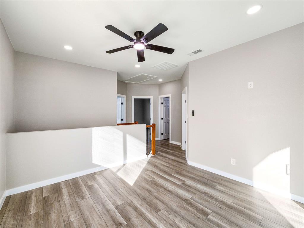1061 Zmolek Road Ennis, TX 75119 - Photo 12 of 40 a view of a hallway with wooden floor and a ceiling fan