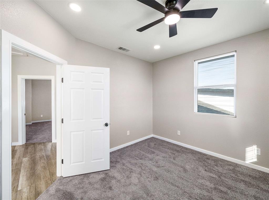1061 Zmolek Road Ennis, TX 75119 - Photo 16 of 40 en empty room with ceiling fan and window