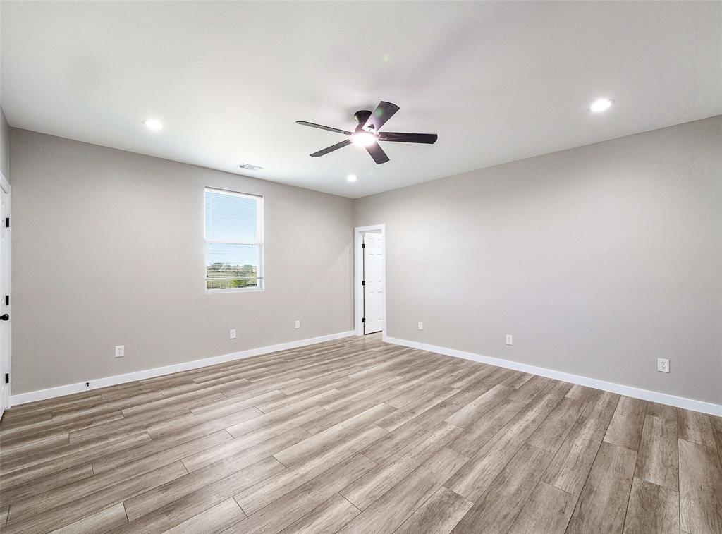 1061 Zmolek Road Ennis, TX 75119 - Photo 23 of 40 an empty room with a window and a ceiling fan