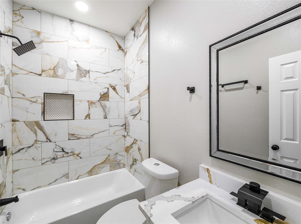 1061 Zmolek Road Ennis, TX 75119 - Photo 25 of 40 a bathroom with a sink toilet and shower