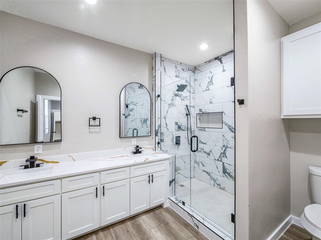 1061 Zmolek Road Ennis, TX 75119 - Photo 26 of 40 a spacious bathroom with double vanity and a mirror