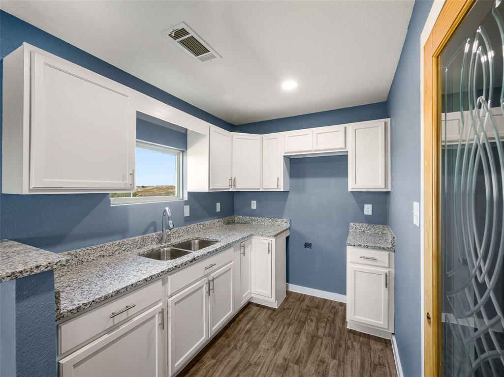1061 Zmolek Road Ennis, TX 75119 - Photo 35 of 40 a kitchen with stainless steel appliances granite countertop a sink stove and refrigerator