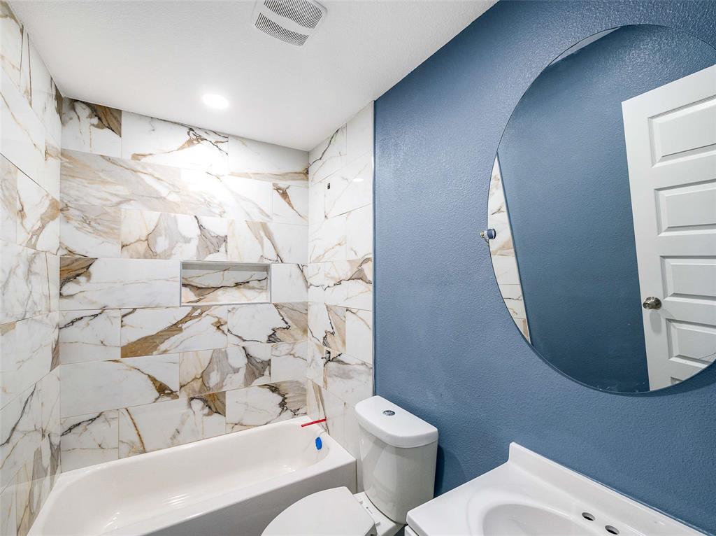 1061 Zmolek Road Ennis, TX 75119 - Photo 37 of 40 a bathroom with a toilet and a shower