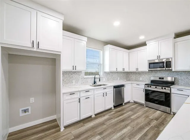 a view of kitchen with wooden floor